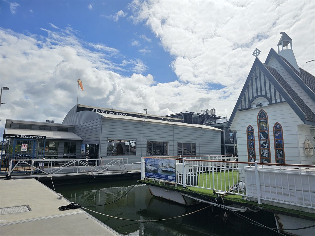 Step 5 — Continue to the end of the jetty, where you'll see our logo on a grey building.